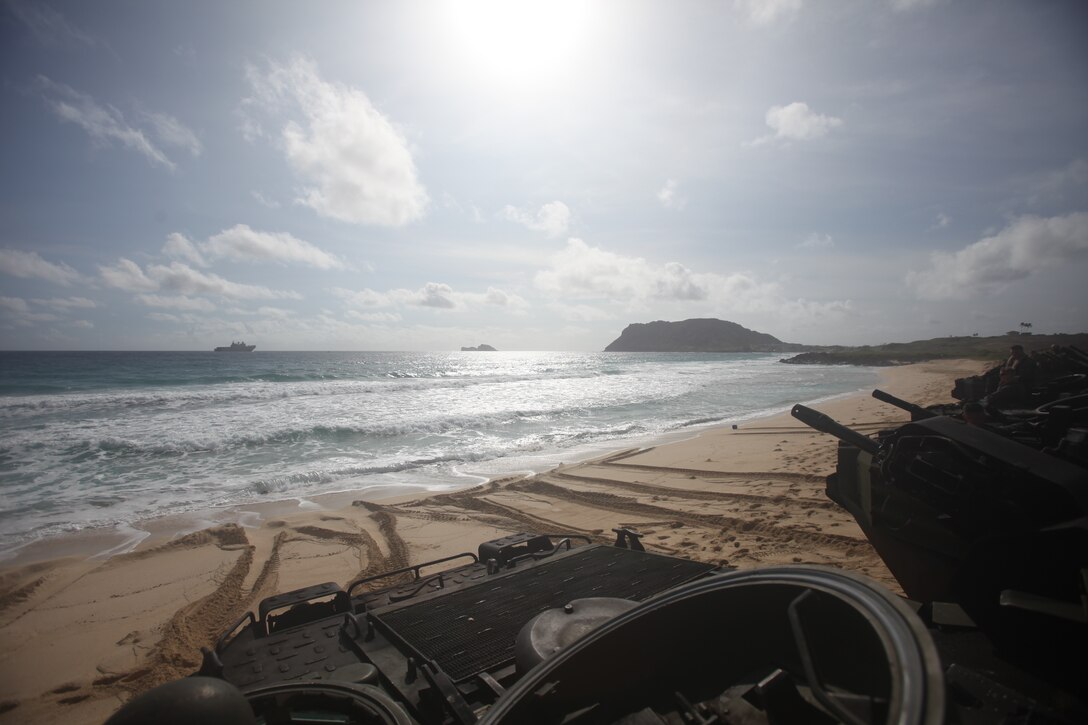 U.S. Marines with Combat Assault Company, 3rd Marine Regiment, stage AAV-P7/A1 assault amphibious vehicles at Pyramid Rock Beach prior to embarking onto the Royal Australian Navy landing helicopter dock ship HMAS Adelaide (L01) as part of Rim of the Pacific (RIMPAC) exercise on Marine Corps Base Hawaii July 10, 2018. RIMPAC provides high-value training for task-organized, highly capable Marine Air-Ground Task Force and enhances the critical crisis response capability of U.S. Marines in the Pacific. Twenty-five nations, 46 ships, five submarines, about 200 aircraft and 25,000 personnel are participating in RIMPAC from June 27 to Aug. 2 in and around the Hawaiian Islands and Southern California. The world's largest international maritime exercise, RIMPAC provides a unique training opportunity while fostering and sustaining cooperative relationships among participants critical to ensuring the safety of sea lanes and security on the world's oceans.