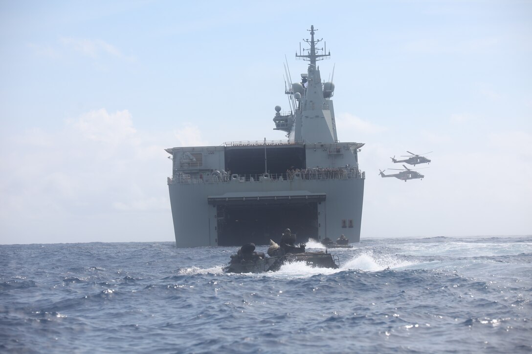U.S. Marines with Combat Assault Company, 3rd Marine Regiment, travel in AAV-P7/A1 assault amphibious vehicles onto the Royal Australian Navy landing helicopter dock ship HMAS Adelaide (L01) as part of Rim of the Pacific (RIMPAC) exercise off the coast of Marine Corps Base Hawaii July 10, 2018. RIMPAC provides high-value training for task-organized, highly capable Marine Air-Ground Task Force and enhances the critical crisis response capability of U.S. Marines in the Pacific. Twenty-five nations, 46 ships, five submarines, about 200 aircraft and 25,000 personnel are participating in RIMPAC from June 27 to Aug. 2 in and around the Hawaiian Islands and Southern California. The world's largest international maritime exercise, RIMPAC provides a unique training opportunity while fostering and sustaining cooperative relationships among participants critical to ensuring the safety of sea lanes and security on the world's oceans. RIMPAC 2018 is the 26th exercise in the series that began in 1971.