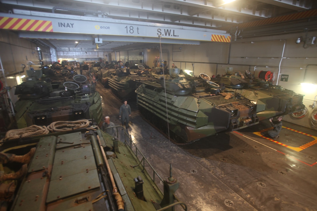 U.S. Marines with Combat Assault Company, 3rd Marine Regiment, stage AAV-P7/A1 assault amphibious vehicles aboard the Royal Australian Navy landing helicopter dock ship HMAS Adelaide (L01) as part of Rim of the Pacific (RIMPAC) exercise off the coast of Marine Corps Base Hawaii July 10, 2018. RIMPAC provides high-value training for task-organized, highly capable Marine Air-Ground Task Force and enhances the critical crisis response capability of U.S. Marines in the Pacific. Twenty-five nations, 46 ships, five submarines, about 200 aircraft and 25,000 personnel are participating in RIMPAC from June 27 to Aug. 2 in and around the Hawaiian Islands and Southern California. The world's largest international maritime exercise, RIMPAC provides a unique training opportunity while fostering and sustaining cooperative relationships among participants critical to ensuring the safety of sea lanes and security on the world's oceans. RIMPAC 2018 is the 26th exercise in the series that began in 1971.