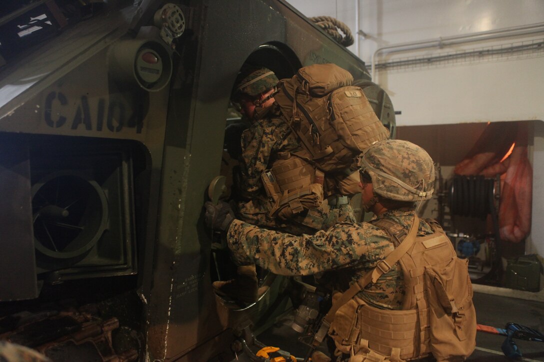 U.S. Marines with Company B, 1st Battalion, 3rd Marine Regiment, load onto an AAV-P7/A1 assault amphibious vehicle aboard the Royal Australian Navy landing helicopter dock ship HMAS Adelaide (L01) as part of Rim of the Pacific (RIMPAC) exercise off the coast of Marine Corps Base Hawaii July 11, 2018. RIMPAC provides high-value training for task-organized, highly capable Marine Air-Ground Task Force and enhances the critical crisis response capability of U.S. Marines in the Pacific. Twenty-five nations, 46 ships, five submarines, about 200 aircraft and 25,000 personnel are participating in RIMPAC from June 27 to Aug. 2 in and around the Hawaiian Islands and Southern California. The world's largest international maritime exercise, RIMPAC provides a unique training opportunity while fostering and sustaining cooperative relationships among participants critical to ensuring the safety of sea lanes and security on the world's oceans. RIMPAC 2018 is the 26th exercise in the series that began in 1971.