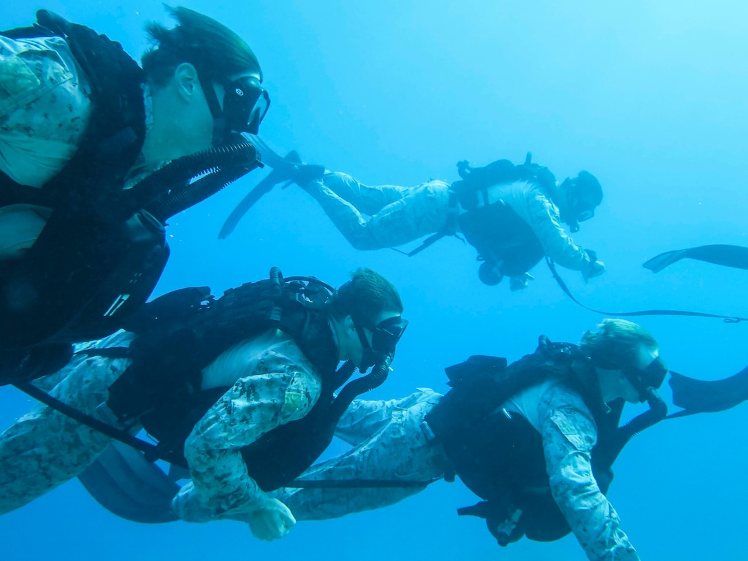 U.S. Marines with Maritime Raid Force, 26th Marine Expeditionary Unit, swim underwater during dive training in Aqaba, Jordan, July 8, 2018. Iwo Jima is deployed to the U.S. 5th Fleet area of operations in support of naval operations to ensure maritime stability and security in the central region, connecting the Mediterranean and the Pacific through the western Indian Ocean and three strategic choke points.