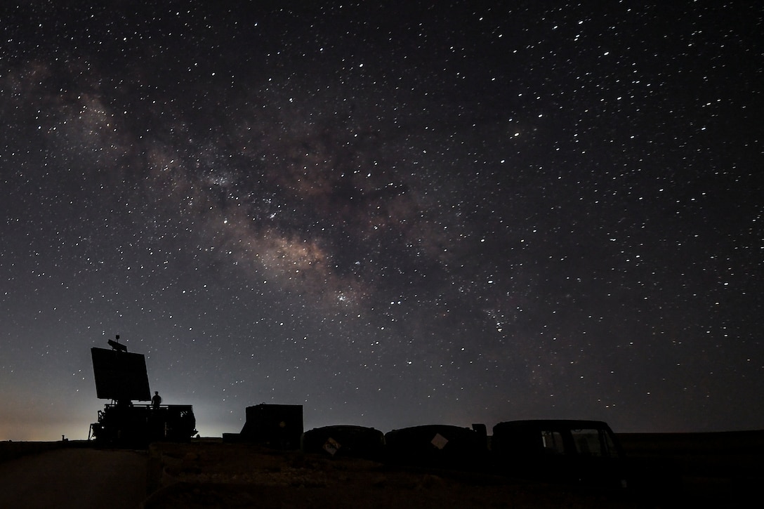 An Airman assigned to the 727th Expeditionary Air Control Squadron stands near a radar site at a coalition airfield in Northeast Syria, July 1, 2018. As the site begins operations, the 727th EACS is able to ensure that the airspace is continually safe and secure across theaters of operations. (U.S. Air Force photo by Staff Sgt. Corey Hook)