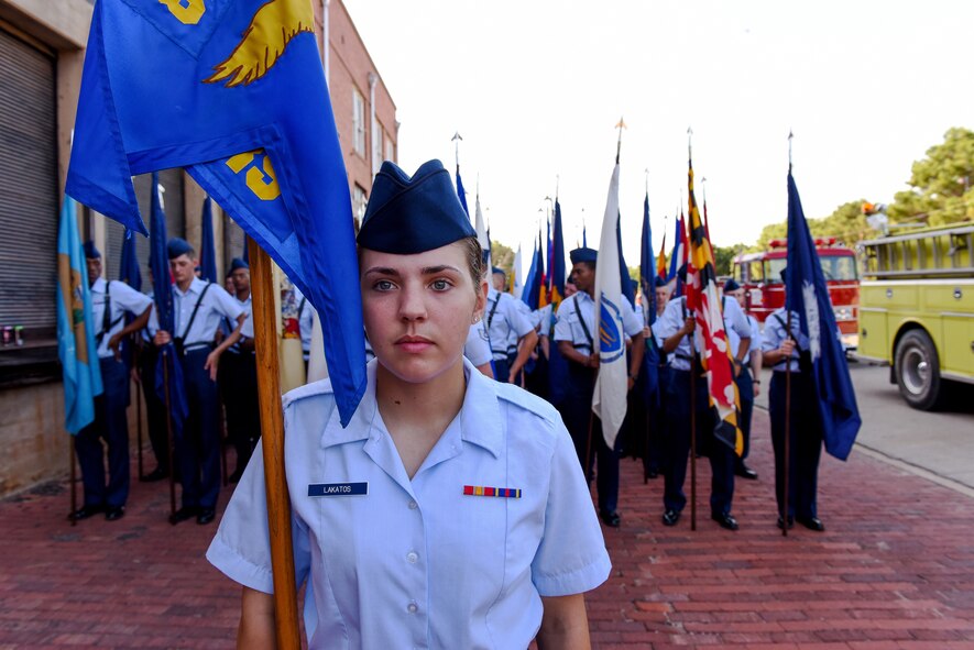 Airman Mackenzie Lakatos, a munitions apprentice student at the 363rd Training Squadron, stands at attention as a flight of Airmen carrying state flags perfects their spacing before the 34th Annual Kell House Museum Fourth of July and Most Patriotic Parade in downtown Wichita Falls, Texas, July 4, 2018. (U.S. Air Force photo by John Ingle)