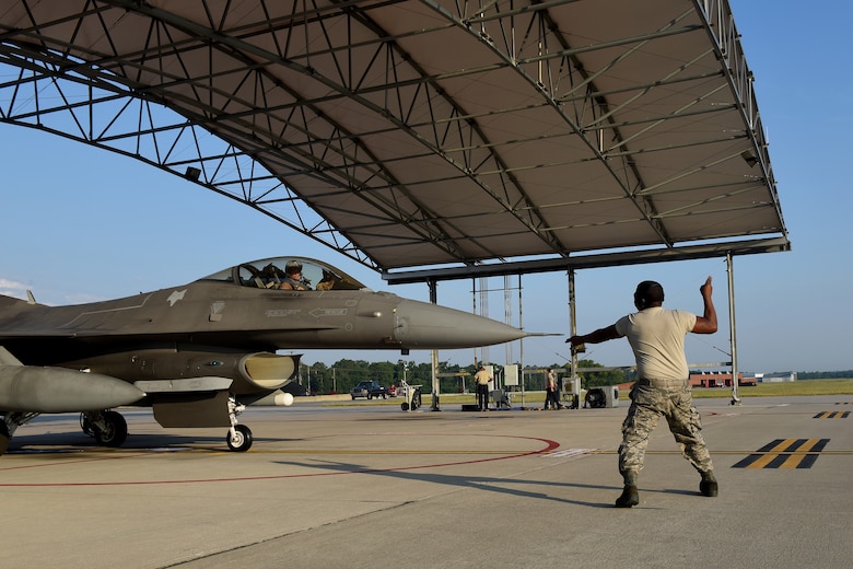 Senior Airman Malcom Brown, a crew chief assigned to the South Carolina Air National Guard's 169th Aircraft Maintenance Squadron, directs a pilot to taxi to the runway at McEntire Joint National Guard Base, South Carolina, July 11, 2018. (U.S. Air National Guard photo by Senior Airman Ashleigh S. Pavelek)