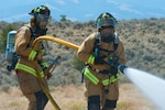 The 1157th Engineer Company (firefighters) from the Colorado National Guard conduct a training exercise to prepare for any real-world incident at the Spring Creek Fire helipad in Fort Garland, Colo., July 6, 2018.