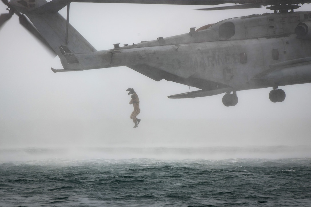 A Canadian troop jumps from a CH-53E Super Stallion during helicopter casting training.