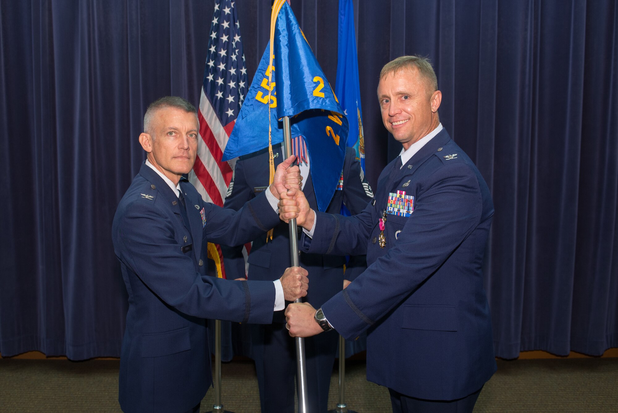 U.S. Air Force Col. Jason Patla, 2nd Weather Group (WXG) commander, relinquishes command of the 2nd WXG to U.S. Air Force Col. Brian Pukall, 557th Weather Wing commander, during a change of command ceremony July 11, 2018, at Offutt Air Force Base, Nebraska. Patla will go on to command Air Force Reserve Officer Training Corps Detachment 157 in Daytona Beach, Florida. (U.S. Air Force photo by Paul Shirk)