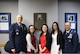 (Left to right) Lt. Col. William Kostan, Kaci Moy, Jodi Moy, Akina Moy and Col. Andrew Torelli gather in front of a plaque honoring Col. James J. Moy. Members of Air Mobility Command’s intelligence community recently dedicated a conference room in Moy’s honor. Moy, an Illinois native and member of the Illinois Air National Guard, died in 2013 after a battle with cancer. (U.S. Air Force photo)