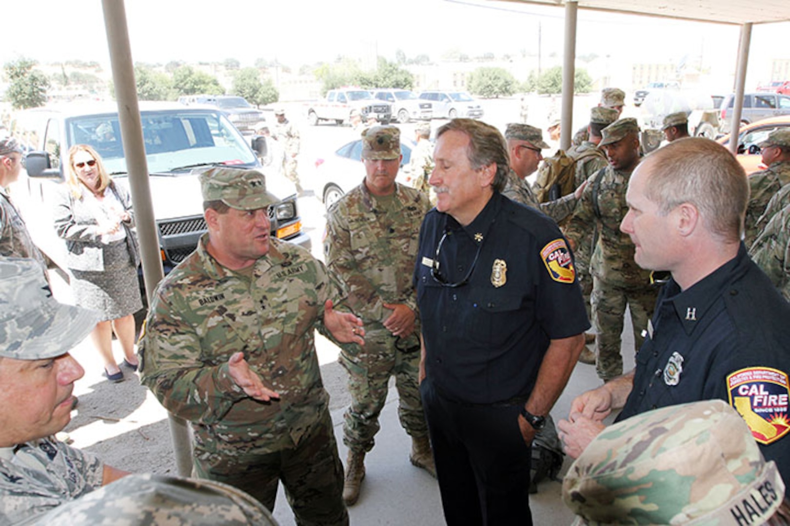 U.S. Army Maj. Gen. David Baldwin, left, adjutant general of the California National Guard, confers with Lt. Col. Jeffrey Corella, commander, 144th Field Artillery Battalion, 100th Troop Command, 40th Infantry Division, and John Winder, military asset coordinator of California’s Department of Forestry and Fire Protection (CAL FIRE) July 12, 2018, at Camp Roberts, California, where more than 500 Guardsmen are training for ground operations to battle wildfires in the next few days.