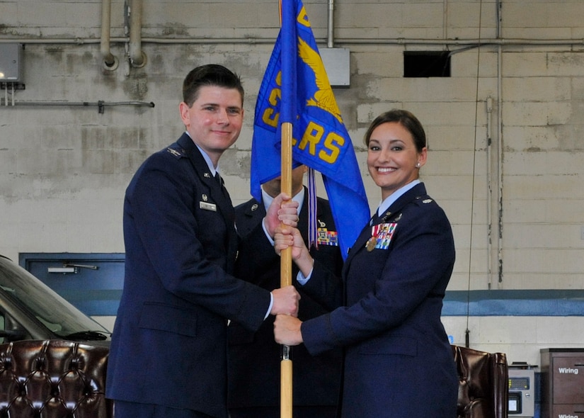 Lt. Col. Abbilyn Johnson, right, relinquishes the 628th Logistics Readiness Squadron guidon to Col. Rockie Wilson, 628th Mission Support Group commander, during the 628th LRS change of command ceremony here, July 13, 2018.