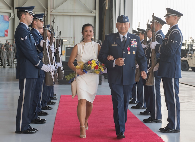 Col. Jimmy Canlas, outgoing 437th Airlift Wing commander, departs with his wife Joy following a change of command ceremony July 12, 2018, in Nose Dock 2.