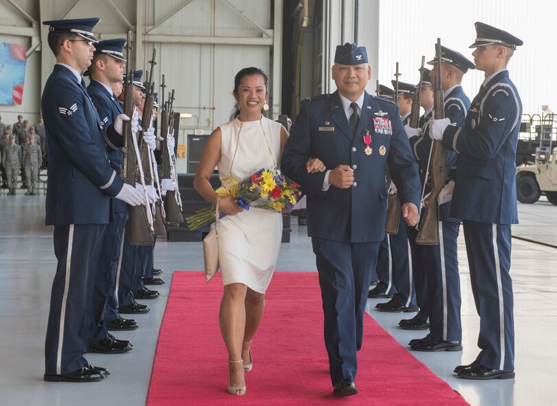 Col. Jimmy Canlas, outgoing 437th Airlift Wing commander, departs with his wife Joy following a change of command ceremony July 12, 2018, in Nose Dock 2.
