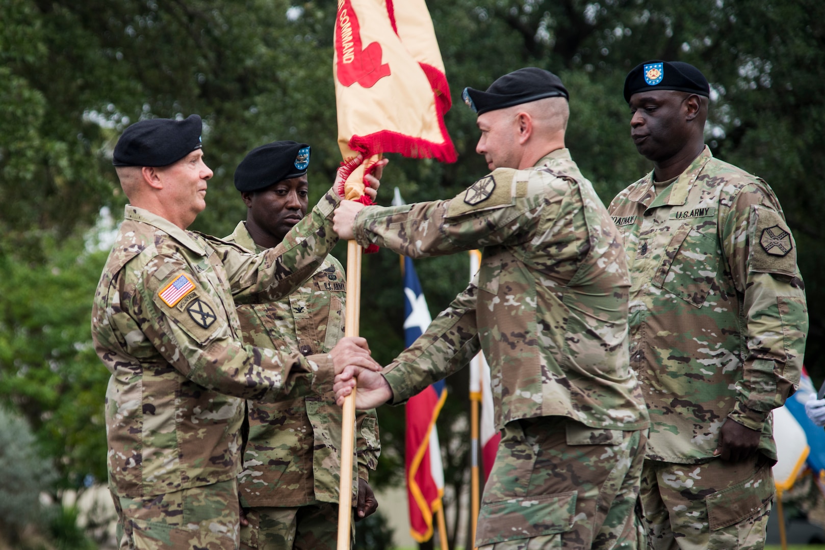 Col. Timothy Greenhaw (center) turns over the colors of the U.S. Army Environmental Command during a change of command ceremony at the U.S. Army North Quadrangle at Joint Base San Antonio-Fort Sam Houston July 11. Col. Isaac Manigault took command of the USAEC from Greenhaw, who led the command for two years. Greenhaw is heading to the Pentagon to work at the Joint Staff J-8 Joint Requirements Office.
