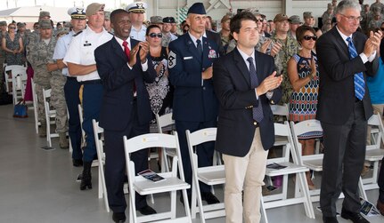 Attendees applaud as command of the 437th Airlift Wing is transferred from Col. Jimmy Canlas to Col. Clinton R. ZumBrunnen during a change of command ceremony July 12, 2018, in Nose Dock 2.