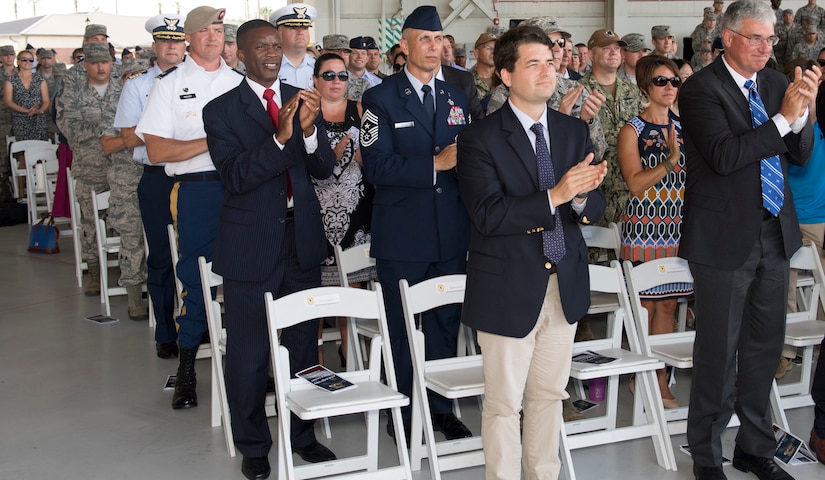 Attendees applaud as command of the 437th Airlift Wing is transferred from Col. Jimmy Canlas to Col. Clinton R. ZumBrunnen during a change of command ceremony July 12, 2018, in Nose Dock 2.