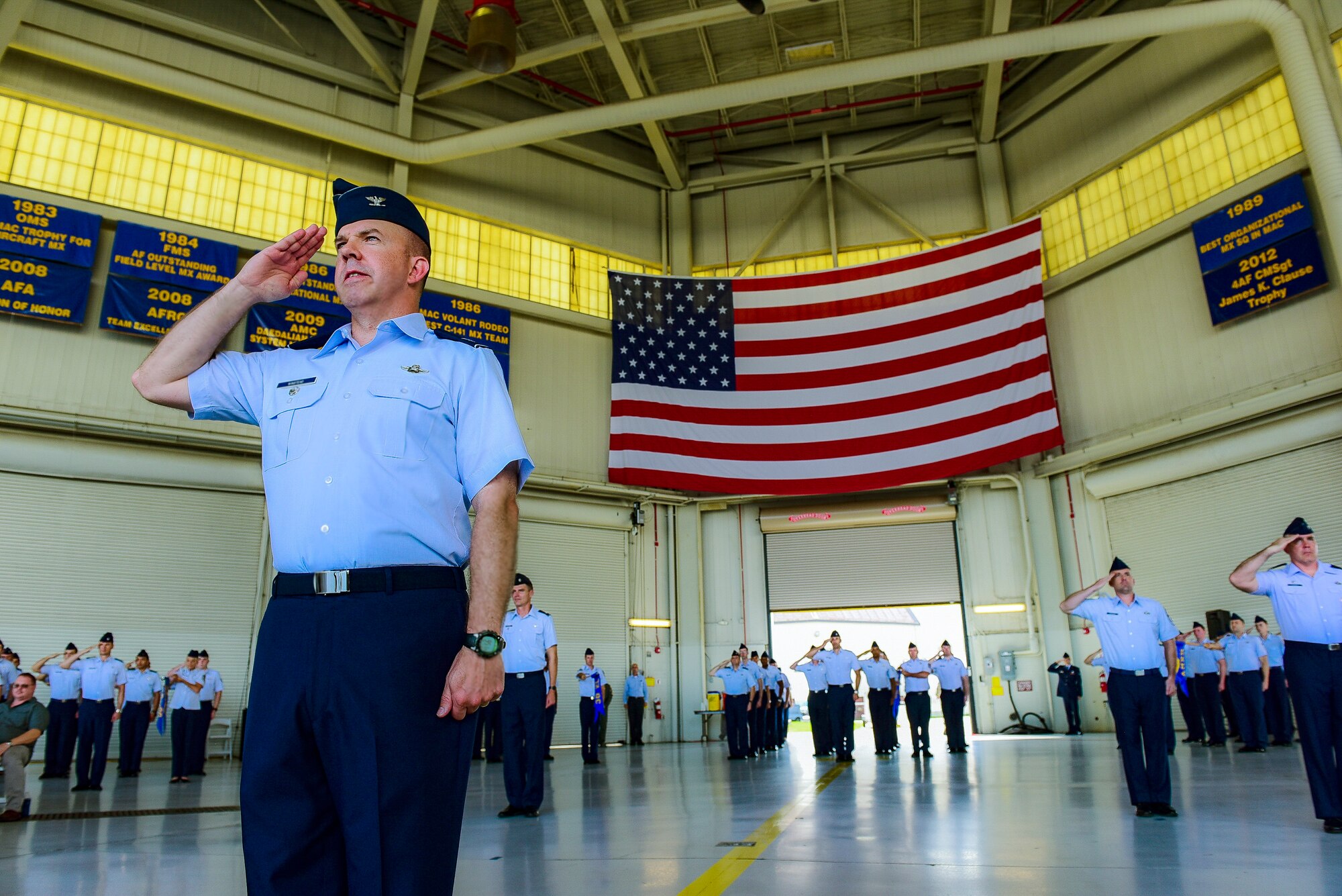 Col. Patrick Winstead, 437th Airlift Wing vice commander, leads a formation of 437th AW Airmen as they render a salute during a change of command July12, 2018 in Nose Dock 2.