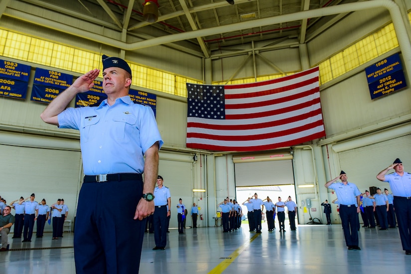 Col. Patrick Winstead, 437th Airlift Wing vice commander, leads a formation of 437th AW Airmen as they render a salute during a change of command July12, 2018 in Nose Dock 2.