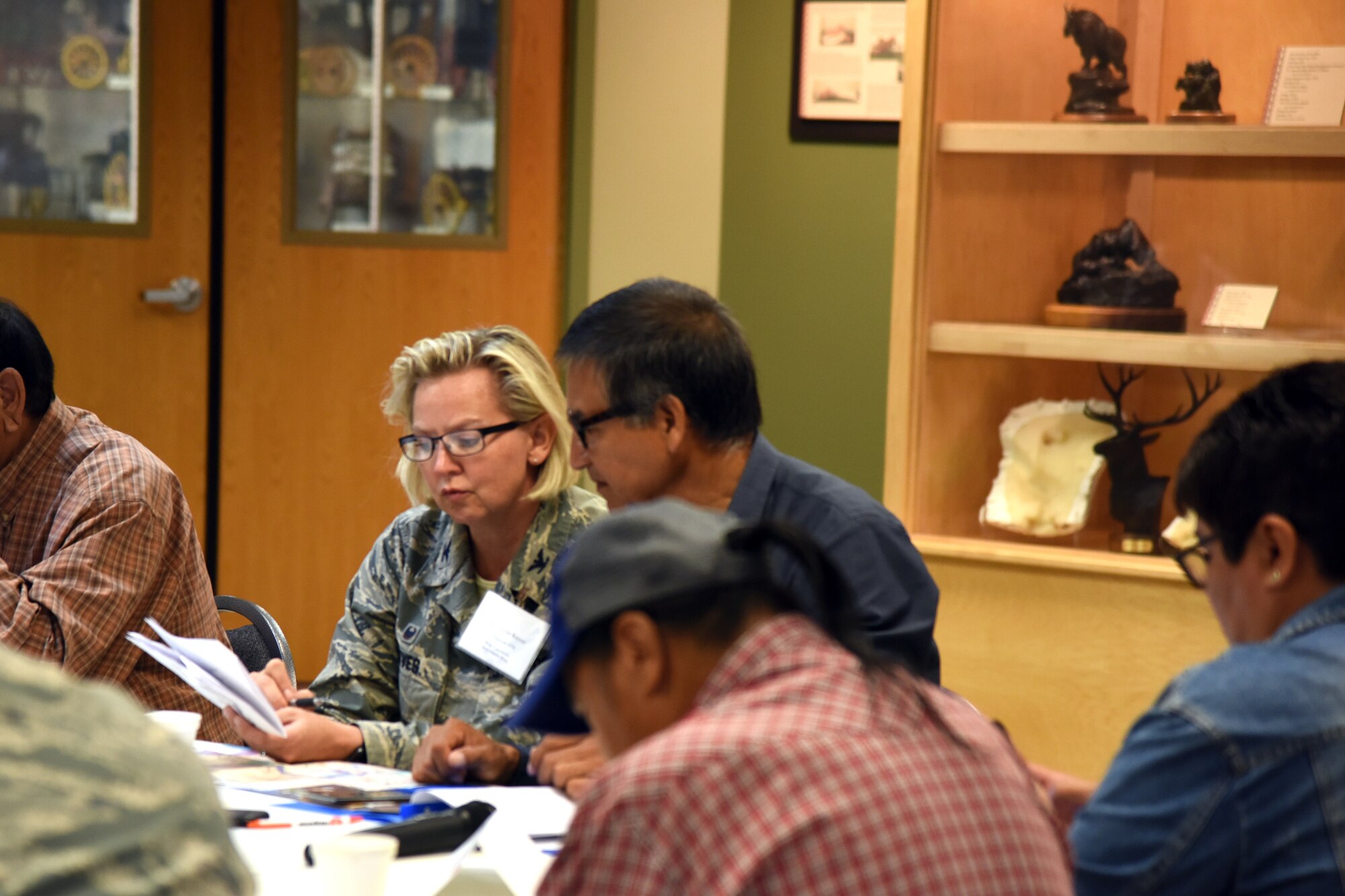 180712-F-UQ541-1151 Col. Jennifer Reeves, 341st Missile Wing commander, and Conrad Fisher, Northern Cheyenne Tribe vice president, exchange information at the third annual tribal relations meeting July 12, 2018, at the C.M. Russell Museum, in Great Falls, Mont. Members of the Blackfeet Nation, Chippewa Cree Tribe, Confederated Salish and Kootenai Tribes, Crow Tribe, Fort Belknap Assiniboine and Gros Ventres Tribes and Northern Cheyenne Tribe also attended the meeting. (U.S. Air Force photo by Kiersten McCutchan)