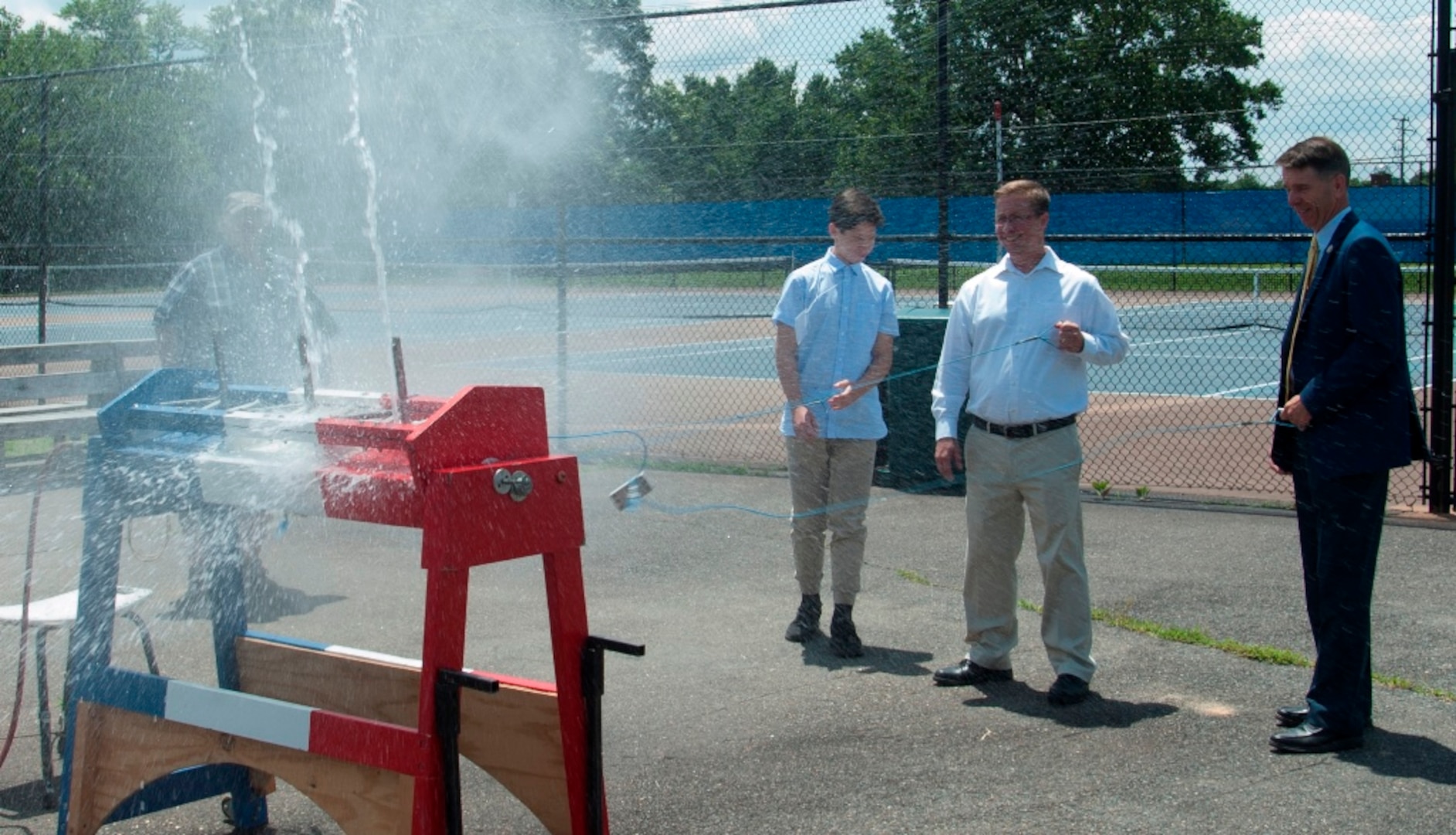 IMAGE: KING GEORGE. Va. (June 25, 2018) - Rep. Rob Wittman (R-Va.) fires a water rocket with a middle school student and a Navy scientist-mentor at the 2018 STEM Summer Academy sponsored by Naval Surface Warfare Center Dahlgren Division. The water rockets were constructed and calibrated by students in conjunction with an aerospace engineering activity. The teachers and mentors inspired students to develop their teamwork and problem-solving skills in math and science throughout the camp.