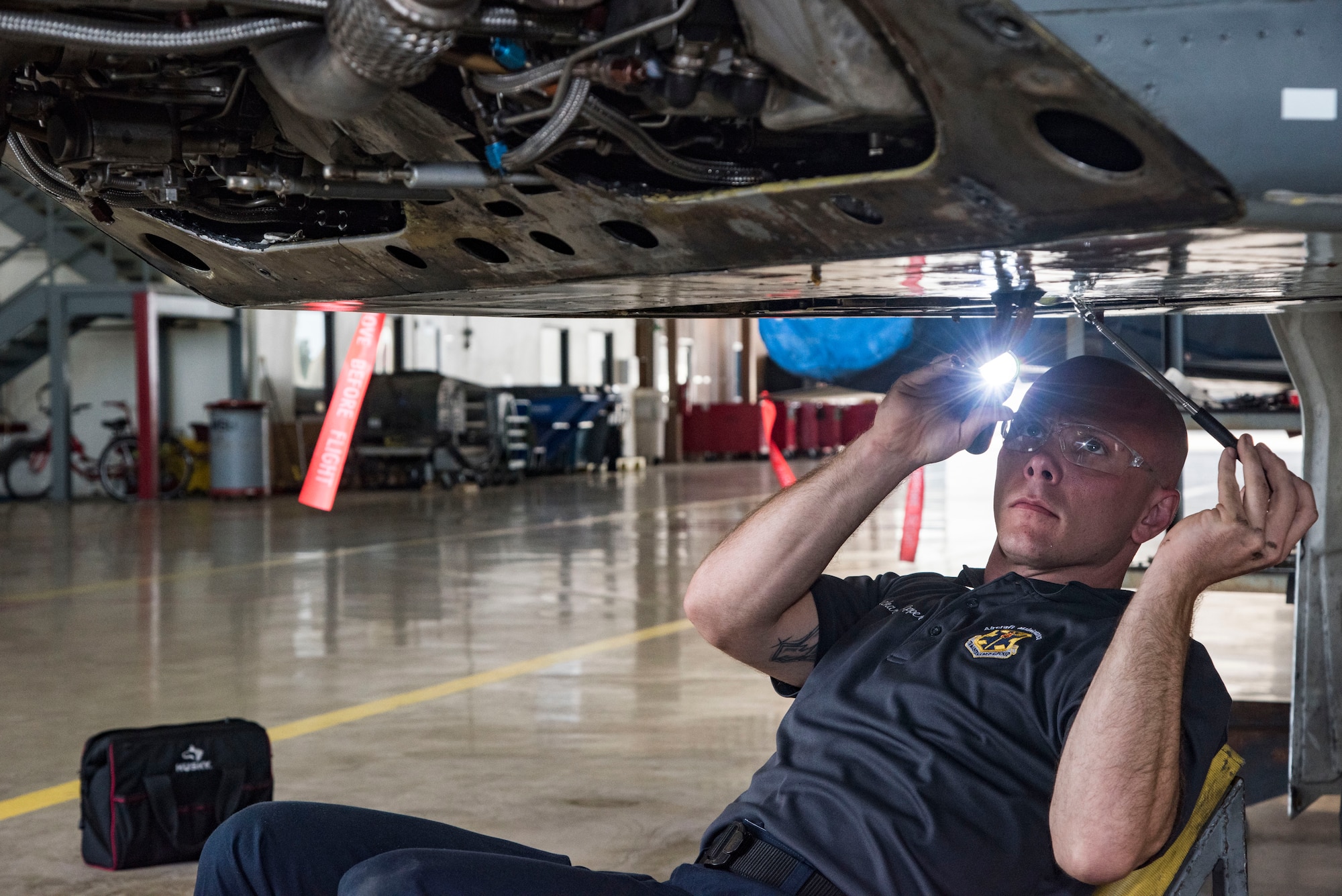 Richard Kilpper, 12th Maintenance Group Quality Assurance Division aircraft engine inspector, inspects the maintenance being performed on a jet engine July 12, 2018, at Joint Base San Antonio-Randolph, Texas. QA evaluates the quality of maintenance accomplished by maintainers and performs necessary functions to manage the wing and group's Maintenance Standardization Evaluation Program. (U.S. Air Force photo by Senior Airman Stormy Archer)