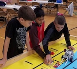 IMAGE: KING GEORGE. Va. (June 28, 2018) - Middle school students prepare to deploy a robot they designed, built, and programmed to deliver humanitarian aid, rotate troops and transport an electromagnetic railgun to the deck of a Navy ship at the 2018 STEM Summer Academy. The students briefed their mentors, teachers, and visitors on how they overcame a variety of Navy focused problems by designing, building, and programming LEGO Mindstorm robots to solve a variety of Navy focused problems.