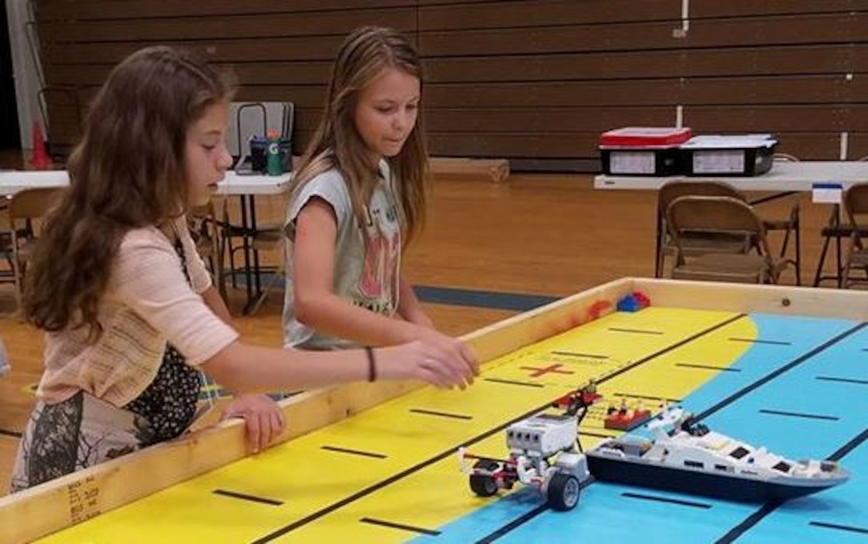 IMAGE: KING GEORGE. Va. (June 28, 2018) - Middle school students prepare to deploy robots they designed, built, and programmed to respond to 10 missions - including the delivery of humanitarian aid, rotating troops and transporting an electromagnetic railgun to the deck of a Navy ship - at the 2018 STEM Summer Academy. The students briefed their mentors, teachers, and visitors on how they overcame a variety of Navy focused problems with STEM, creativity, communication, and teamwork throughout the week-long academy.