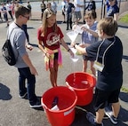 IMAGE: KING GEORGE. Va. (June 25, 2018) - Middle school students determine the optimal amount of fuel (water in this case) required to launch a water rocket the highest. The students - who constructed and calibrated their water rockets in conjunction with an aerospace engineering activity - briefed their mentors, teachers, and visitors on how they overcame a variety of Navy focused problems with STEM, creativity, communication, and teamwork throughout the week-long academy.