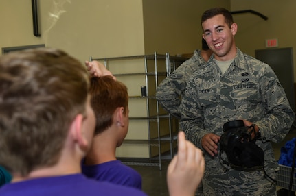 Airman 1st Class Cam Polson, 628th Civil Engineer Squadron emergency management operator, instructs students from the Joseph Pye Elementary School Summer Camp on the use of different tools and equipment for assessing and protecting from chemical incidents during a Science, Technology, Engineering, Art and Mathematics event July 12, 2018, at the emergency management building at Joint Base Charleston, S.C.