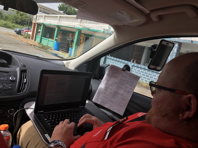 A member of the Pittsburgh Temporary Power Mission in Puerto Rico inputs data in the Englink system while in the field.