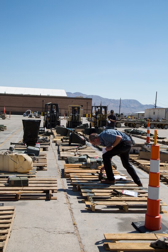 Personnel with the Principle End Items Branch at Production Plant Barstow, Marine Depot Maintenance Command, work as a team to move, sort, tag and organize vehicle components in the centralized disassembly area at their facility on the Yermo Annex aboard Marine Corps Logistics Base Barstow, Calif., July 3. The centralized disassembly area allows for easy access for all of the departments withing PE and I Branch.