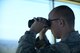 Senior Airman Grant Krause, a 28th Operations Support Squadron air traffic control journeyman, monitors at the flight line through binoculars inside the air traffic control tower at Ellsworth Air Force Base, S.D., July 10, 2018. Air traffic controllers are qualified to work on both the tower, which coordinates movement on the flight line, and the radar approach control team, which coordinates aircraft movement in the sky. (U.S. Air Force photo by Airman 1st Class Nicolas Z. Erwin)