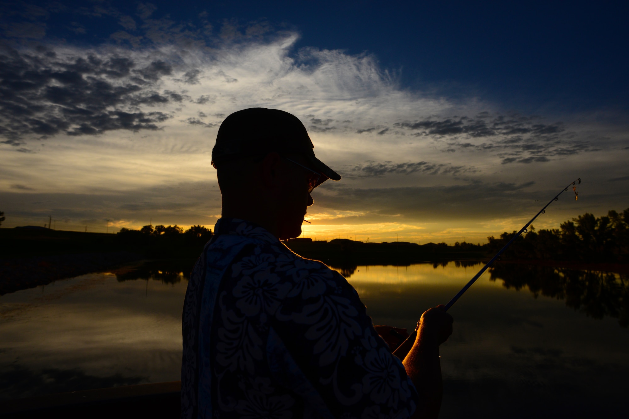 Airman John Ennis, a 28th Bomb Wing Public Affairs broadcast journalist, prepares to cast his fishing rod at Gateway Lake on Ellsworth Air Force Base, S.D., July 12, 2018. Caution is advised as snapping turtles have been seen in lakes located across the base. (U.S. Air Force photo by Airman 1st Class Nicolas Z. Erwin)