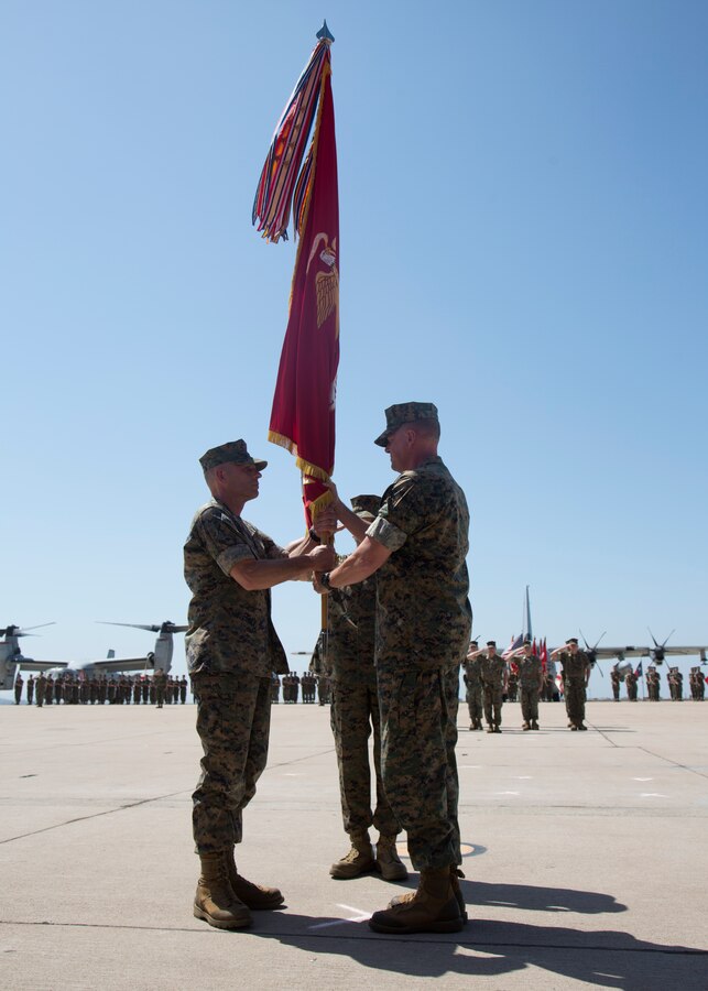 Maj. Gen. Mark R. Wise, outgoing commanding general of 3rd Marine Aircraft Wing, passes the flag to Maj. Gen. Kevin M. Iiams, incoming commanding general, during their change of command ceremony at Marine Corps Air Station Miramar, Calif., July 13. Wise, who took command of 3rd MAW July 22, 2016 and trained, equipped and deployed Marines with four Marine Expeditionary Units and with Special Purpose Marine Air-Ground Task Force-Crisis Response-Central Command. 3rd MAW also continued its modernization with the standup of the first three operational F-35 Lightning II squadrons and the final transition from the AH-1W Super Cobra and UH-1N Huey to the AH-1Z Viper and UH-1Y Venom. His next duty assignment is the Marine Corps Combat Development Command in Washington, D.C. (U.S. Marine Corps photograph by Cpl. Joshua S. McAlpine/Released)