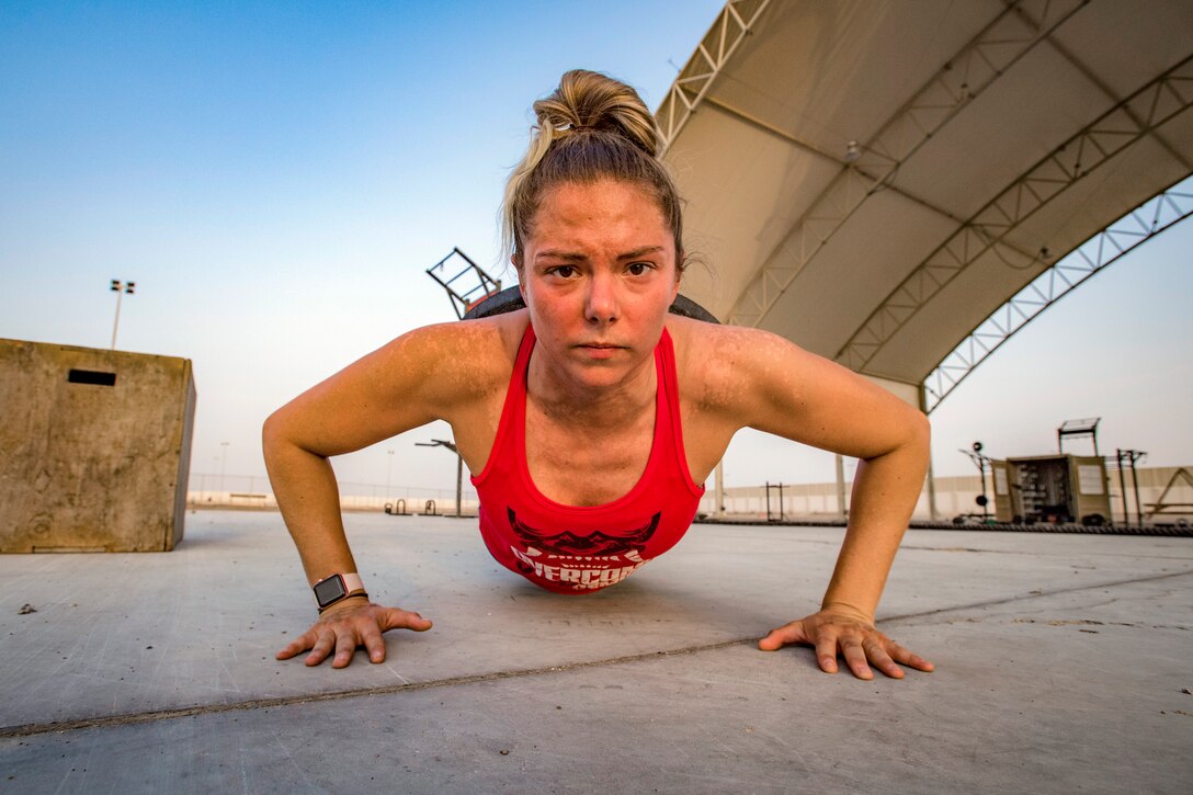 An airman does a pushup.