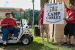 Retired Command Sgt. Maj. Gary Conley, West Virginia National Guard Youth Camp Director, is presented with a banner in honor of all his hard work throughout the years in support of the West Virginia National Guard Youth Programs that certifies the West Virginia Adjutant General, Maj. Gen. James Hoyer's decision to rename the West Virginia National Guard Kids Kamp to Camp Conley. The camp started in 1991 and gives children of service members a chance to experience some of the aspects of military life that their parents or family members endure during deployments.