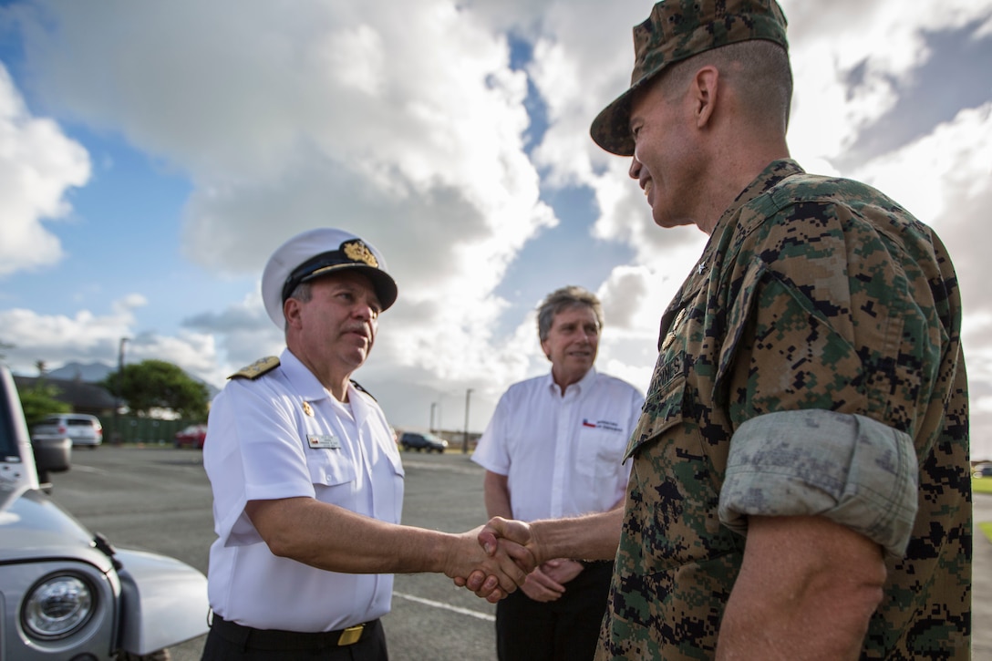 Chilean Navy Adm. Julio Leiva, Chilean Navy Commander-in-Chief, shakes hands with U.S. Marine Corps Brig. Gen. Mark Hashimoto, component commander, Fleet Marine Force, during Rim of the Pacific (RIMPAC) exercise on Marine Corps Base Hawaii July 11, 2018. RIMPAC provides high-value training for task-organized, highly capable Marine Air-Ground Task Force and enhances the critical crisis response capability of U.S. Marines in the Pacific. Marines in the Pacific. Twenty-five nations, 46 ships, five submarines, about 200 aircraft and 25,000 personnel are participating in RIMPAC from June 27 to Aug. 2 in and around the Hawaiian Islands and Southern California.