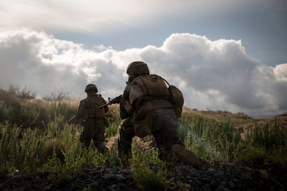 U.S. Marines with Bravo Company, 1st Battalion, 3rd Marine Regiment, maneuver to secure a notional enemy position during a live-fire training event as part of Rim of the Pacific (RIMPAC) exercise at Pohakuloa Training Area, Hawaii, July 13, 2018. The live-fire training integrated fire teams from other RIMPAC participants with U.S. Marines, which provides high-value training for task-organized, highly capable Marine Air-Ground Task Force and enhances the critical crisis response capability of U.S. Marines in the Pacific. Twenty-five nations, 46 ships, five submarines, about 200 aircraft and 25,000 personnel are participating in RIMPAC from June 27 to Aug. 2 in and around the Hawaiian Islands and Southern California. (U.S. Marine Corps photo by Lance Cpl. Adam Montera)