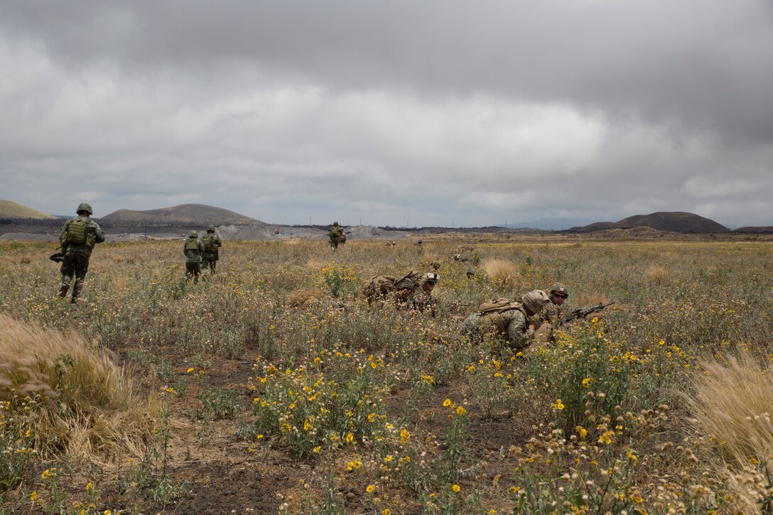 Philippine and U.S. Marines maneuver toward an objective during a noncombatant evacuation operation (NEO) training event as part of Rim of the Pacific (RIMPAC) exercise at Pohakuloa Training Area, Hawaii, July 12, 2018. A NEO is conducted to evacuate U.S. citizens whose lives are in danger. RIMPAC provides high-value training for task-organized, highly capable Marine Air-Ground Task Force and enhances the critical crisis response capability of U.S. Marines in the Pacific. Twenty-five nations, 46 ships, five submarines, about 200 aircraft and 25,000 personnel are participating in RIMPAC from June 27 to Aug. 2 in and around the Hawaiian Islands and Southern California. (U.S. Marine Corps photo by Lance Cpl. Adam Montera)