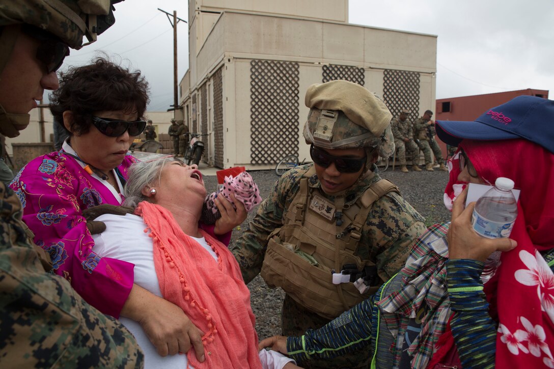 U.S. Navy Hospital Corpsman 3rd Class Miguel Turiano, a corpsman with Alpha Company, 1st Battalion, 3rd Marine Regiment, notionally provides medical care to a role player during a noncombatant evacuation operation (NEO) training event as part of Rim of the Pacific (RIMPAC) exercise at Pohakuloa Training Area, Hawaii, July 12, 2018. A NEO is conducted to evacuate citizens whose lives are in danger. RIMPAC provides high-value training for task-organized, highly capable Marine Air-Ground Task Force and enhances the critical crisis response capability of U.S. Marines in the Pacific.