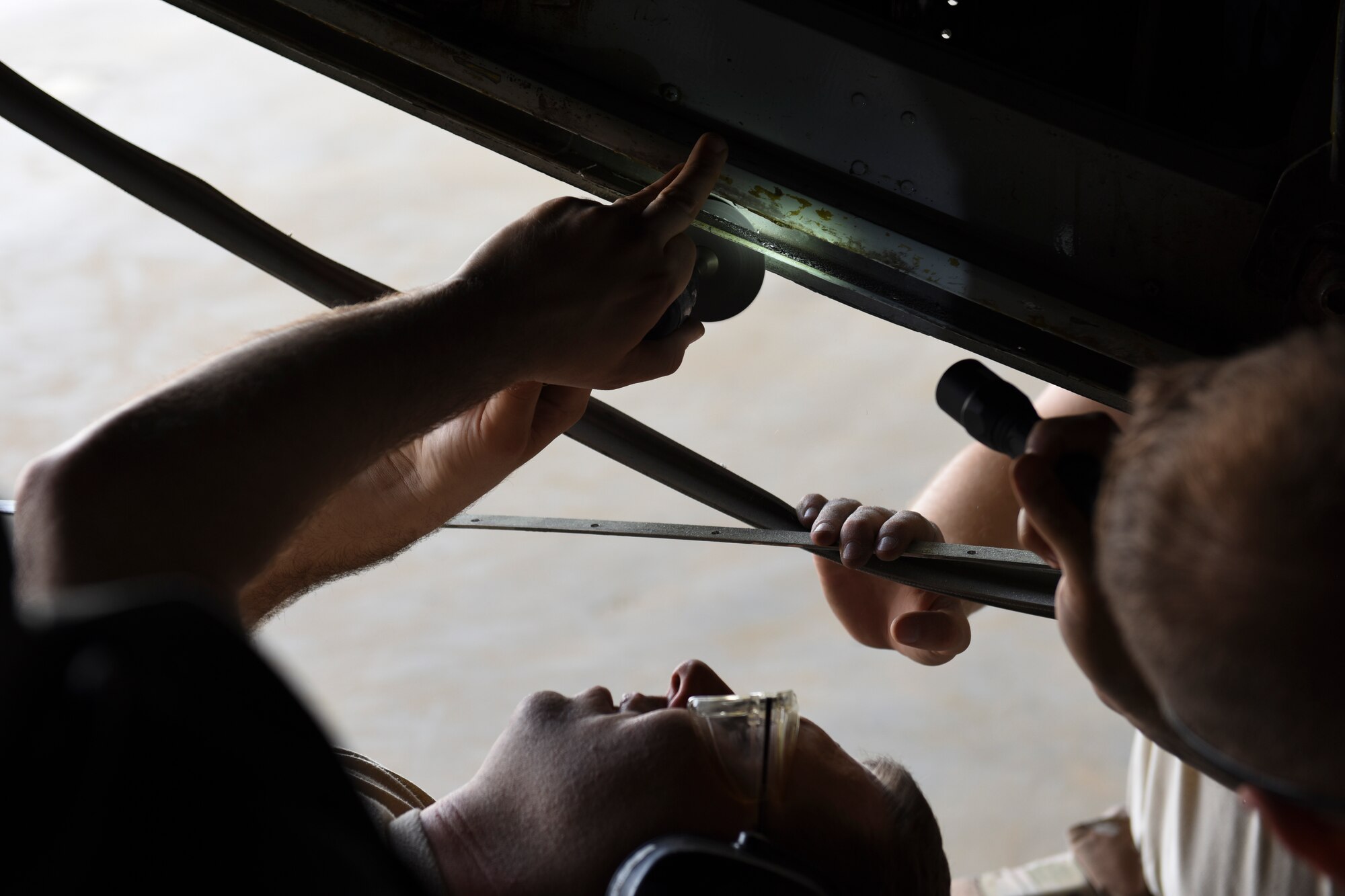 U.S. Air Force Master Sgt. Robert Stanley, 386th Expeditionary Maintenance Squadron combat metals flight aircraft structures craftsman, cuts a piece of metal on an EC-130H Compass Call aircraft June 30, 2018, at an undisclosed location in Southwest Asia. The combat metals flight is repairing a primary structure on the aircraft to ensure it is mission capable. (U.S. Air Force photo by Tech. Sgt. Caleb Pierce)