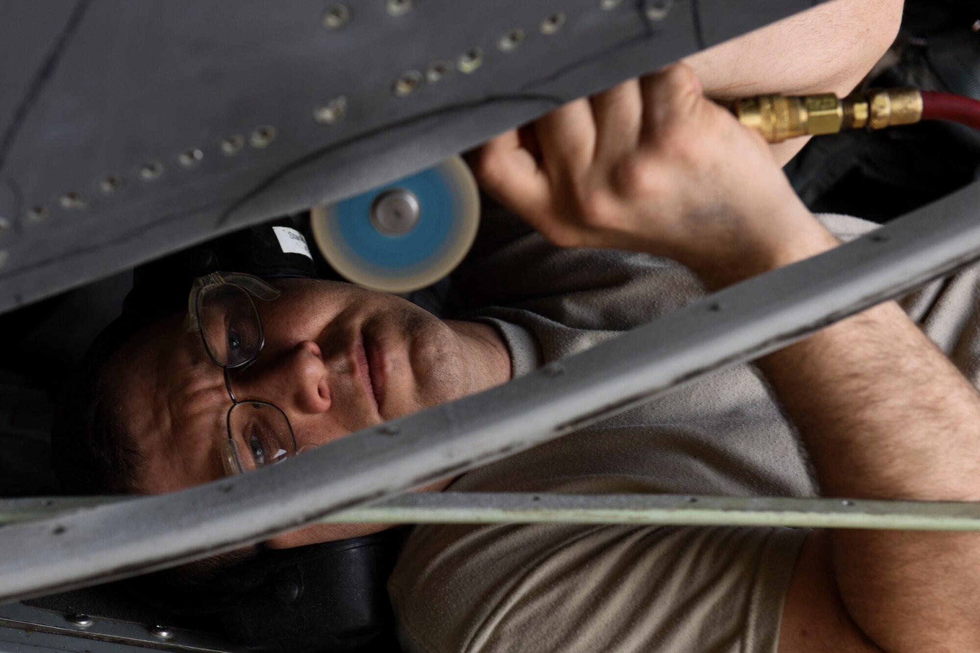 U.S. Air Force Master Sgt. Robert Stanley, 386th Expeditionary Maintenance Squadron combat metals flight aircraft structures craftsman, cuts a piece of metal on an EC-130H Compass Call aircraft June 30, 2018, at an undisclosed location in Southwest Asia. The combat metals flight repaired a section of the aircraft to be structurally sound for flight operations. (U.S. Air Force photo by Tech. Sgt. Caleb Pierce)