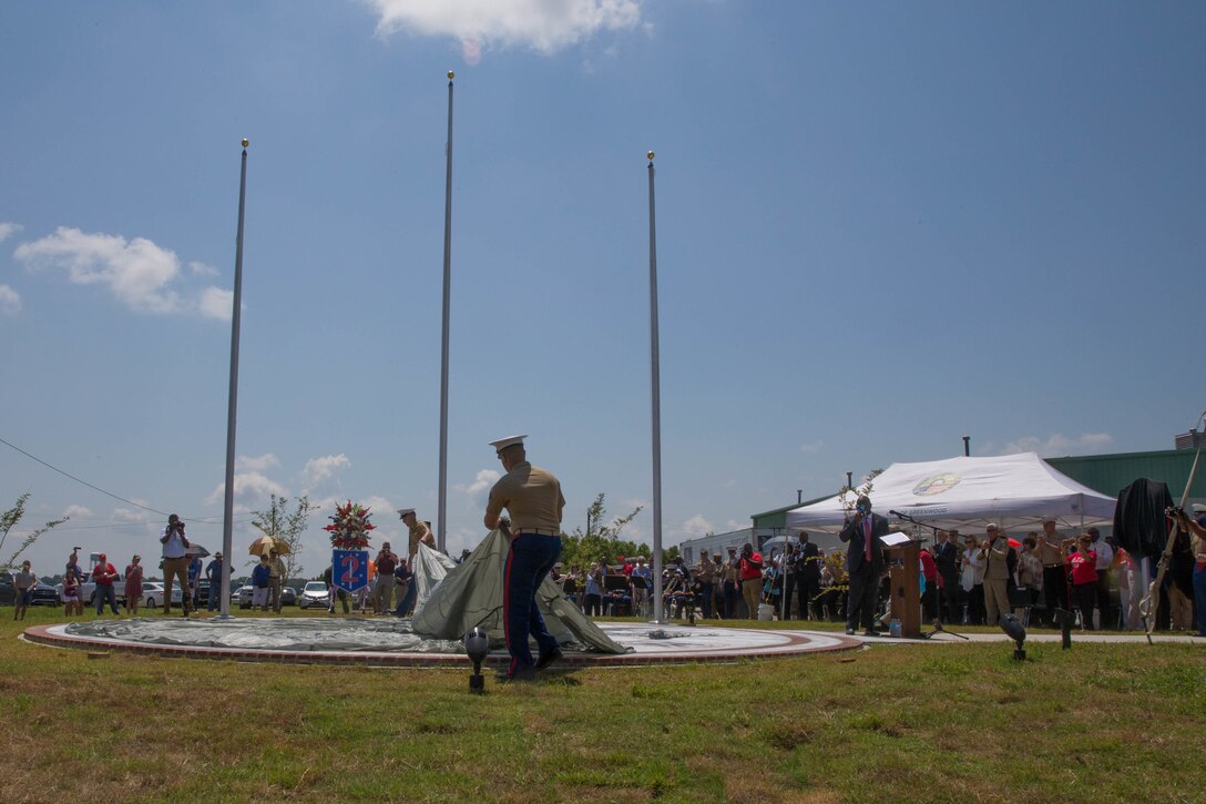 Marines with Marine Aerial Refueler Transport Squadron 452, Marine Aircraft Group 49, 4th Marine Aircraft Wing, unveil the Memorial Marker dedicated to honor the sacrifice of the fallen passengers and crew of Yanky 72, during the Memorial Ceremony, July 14, 2018. The Yanky 72 Memorial Ceremony was held to remember and honor the ultimate sacrifices made by the fallen Marines and Sailor of VMGR-452 and Marine Corps Special Operations Command. (U.S. Marine Corps photo by Lance Cpl. Samantha Schwoch/released)