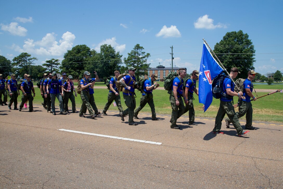 The Rucking Raiders begin the 900 mile ruck march to Camp Lejeune, N.C., from the Memorial Marker in Greenwood, Miss. To Camp Lejeune, N.C., on July 14, 2018. The Rucking Raiders, consisting of 4 rotating teams, are carrying dirt from the crash site of the fallen Marines and Sailor, back to the home station of Camp Lejeune, N.C. (U.S. Marine Corps photo by Lance Cpl. Samantha Schwoch/released)