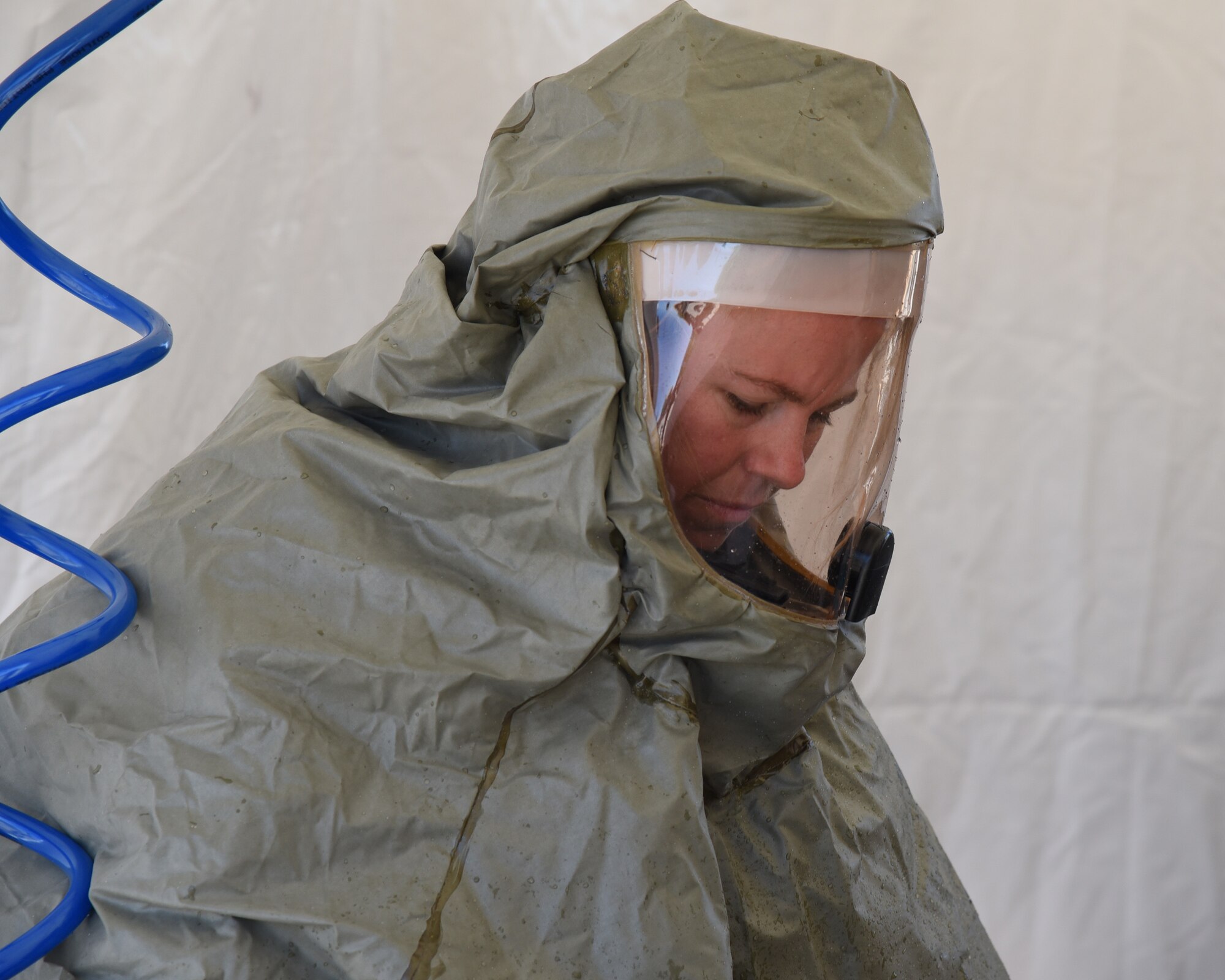 Tech. Sgt. Charity Stuart, an In-Place Patient Decontamination team member, processes a patient through an IPPD station during an exercise at the Goldwater Air National Base, May 22. The purpose of the exercise was to train and evaluate the IPPD team's ability to receive and decontaminate patients in preperation to be elivated to a higher level of medical care. (U.S. Air National Guard photo by Staff Sgt. Wes Parrell)