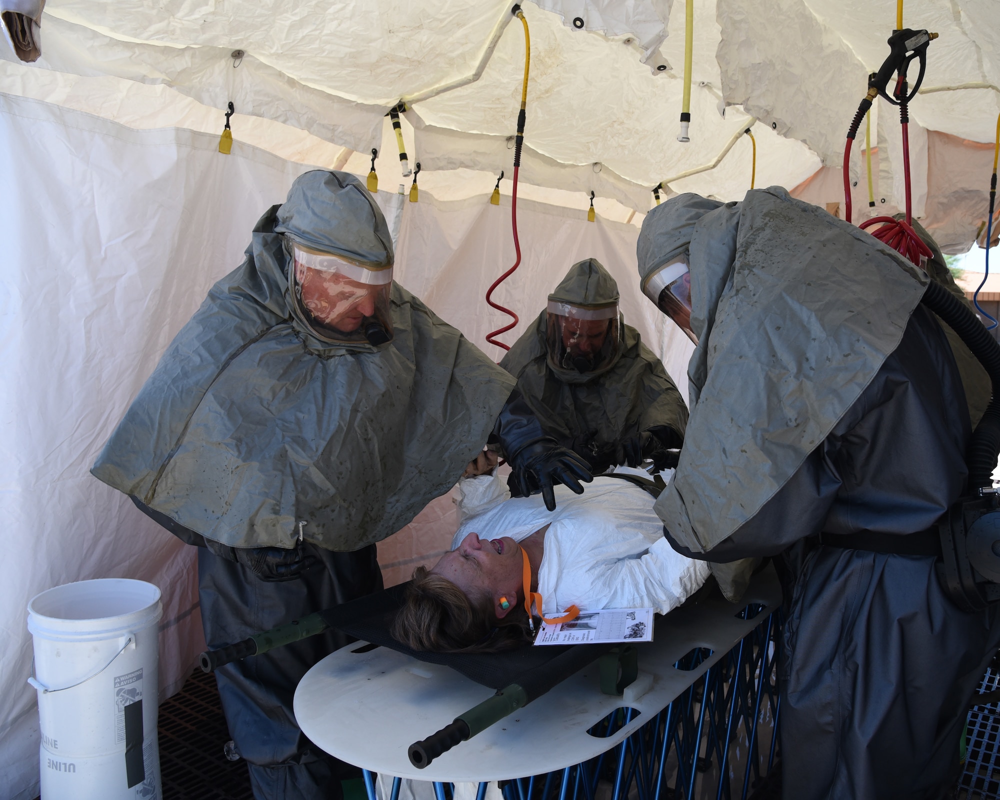 through an In-Place Patient Decontamination station during an exercise at the Goldwater Air National Guard Base, May 22. The purpose of the exercise was to train and evaluate the IPPD team's ability to decontaminate and prepare a patient to be transported onto a higher level of medical care. (U.S. National Guard photo by Staff Sgt. Wes Parrell)