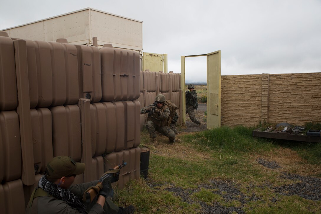 Republic of Korea and U.S. Marines engage an enemy combatant role player during a noncombatant evacuation operation (NEO) training event as part of Rim of the Pacific (RIMPAC) exercise at Pohakuloa Training Area, Hawaii, July 12, 2018. A NEO is conducted to evacuate citizens whose lives are in danger. RIMPAC provides high-value training for task-organized, highly capable Marine Air-Ground Task Force and enhances the critical crisis response capability of U.S. Marines in the Pacific.
