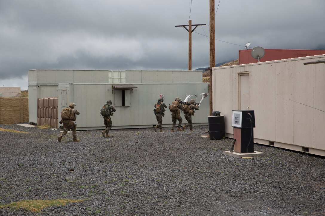 Republic of Korean and U.S. Marines maneuver through an urban area during a noncombatant evacuation operation (NEO) training event as part of Rim of the Pacific (RIMPAC) exercise at Pohakuloa Training Area, Hawaii, July 12, 2018. A NEO is conducted to evacuate citizens whose lives are in danger. RIMPAC provides high-value training for task-organized, highly capable Marine Air-Ground Task Force and enhances the critical crisis response capability of U.S. Marines in the Pacific.