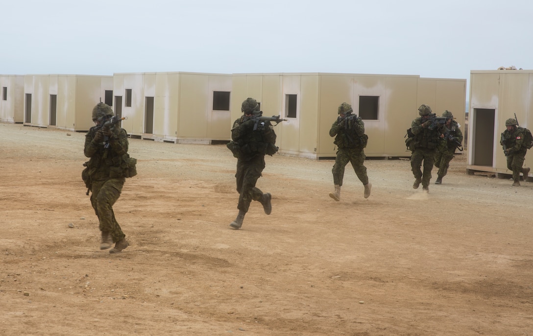 Canadian soldiers with the Royal 22e Régiment advance to the next objective during an amphibious raid as part of Rim of the Pacific (RIMPAC) exercise on Marine Corps Base Camp Pendleton, California, July 13, 2018. This evolution provided an opportunity for participating nations to share best practices which included loading and unloading drills as well as squad attacks. RIMPAC demonstrates the value of amphibious forces and provides high-value training for task-organized, highly capable Marine Air-Ground Task Forces enhancing the critical crisis response capability of U.S. forces and partners globally.