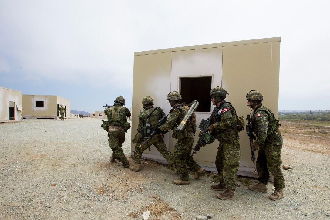 Canadian soldiers with the Royal 22e Régiment advance to the next objective during an amphibious raid as part of Rim of the Pacific (RIMPAC) exercise on Marine Corps Base Camp Pendleton, California, July 13, 2018. This evolution provided an opportunity for participating nations to share best practices which included loading and unloading drills as well as squad attacks. RIMPAC demonstrates the value of amphibious forces and provides high-value training for task-organized, highly capable Marine Air-Ground Task Forces enhancing the critical crisis response capability of U.S. forces and partners globally.