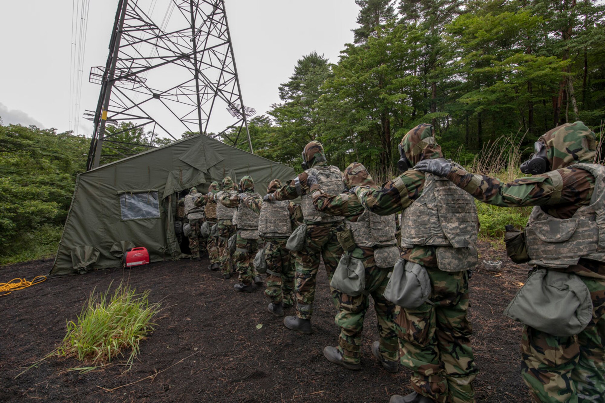Airmen with the 374th Airlift Wing enter the gas mask confidence chamber during Chemical, Biological, Radiological and Nuclear training